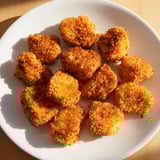 Homemade chicken nuggets with a crunchy breading, offering a delicious, satisfying bite.