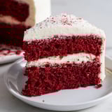 Moist Red Velvet Cake slices, beautifully frosted and decorated, a festive dessert option.