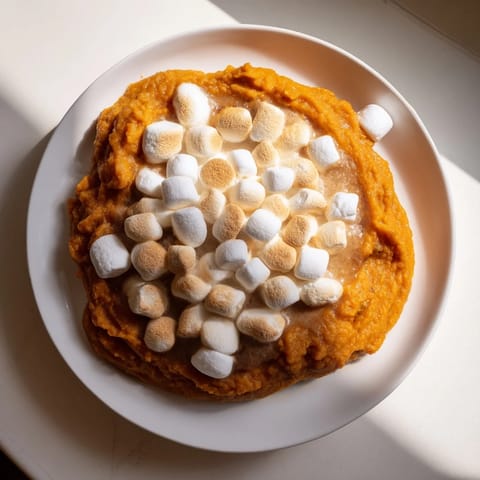 Golden brown Sweet Potato Casserole, a Thanksgiving favorite with a sweet marshmallow topping.