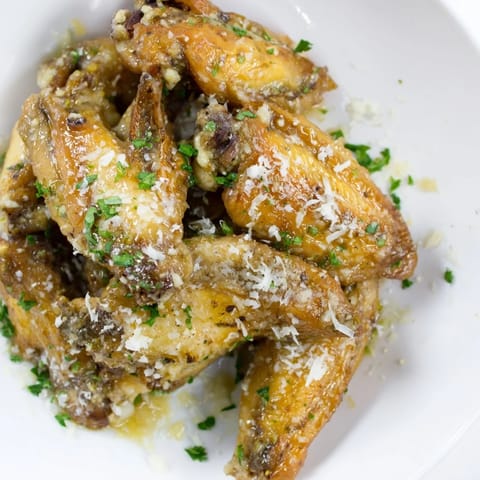 Close-up of Garlic Parmesan Wings, perfectly coated in garlic butter and Parmesan cheese.