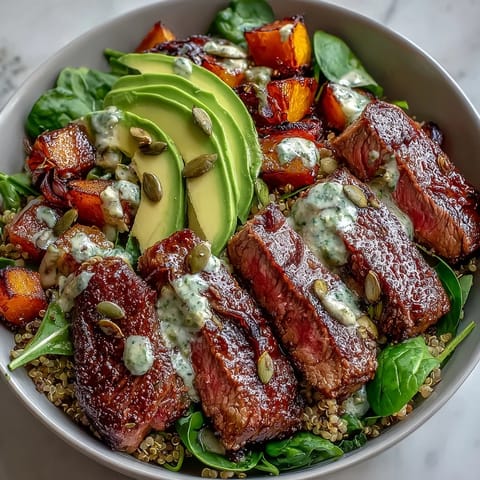 Fork-tender butternut squash steak bowls served with smoky seared flank steak, creamy avocado, and pepitas for crunch.