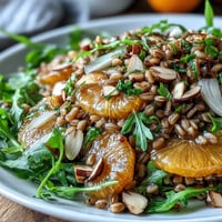 Bright and vibrant Farro Salad with Fennel, Oranges, and Almonds, featuring chewy grains, crisp citrus segments, and toasted nuts on a platter.