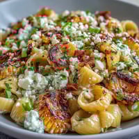 Vibrant Elote Corn Pasta Salad with creamy Cotija cheese and smoky charred corn, perfect for summer gatherings or picnics.
